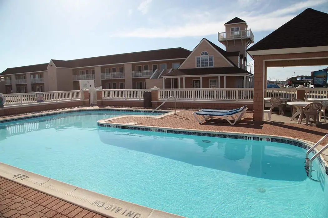 The outdoor pool by daylight, with the inn's guest wing and shingled tower behind it